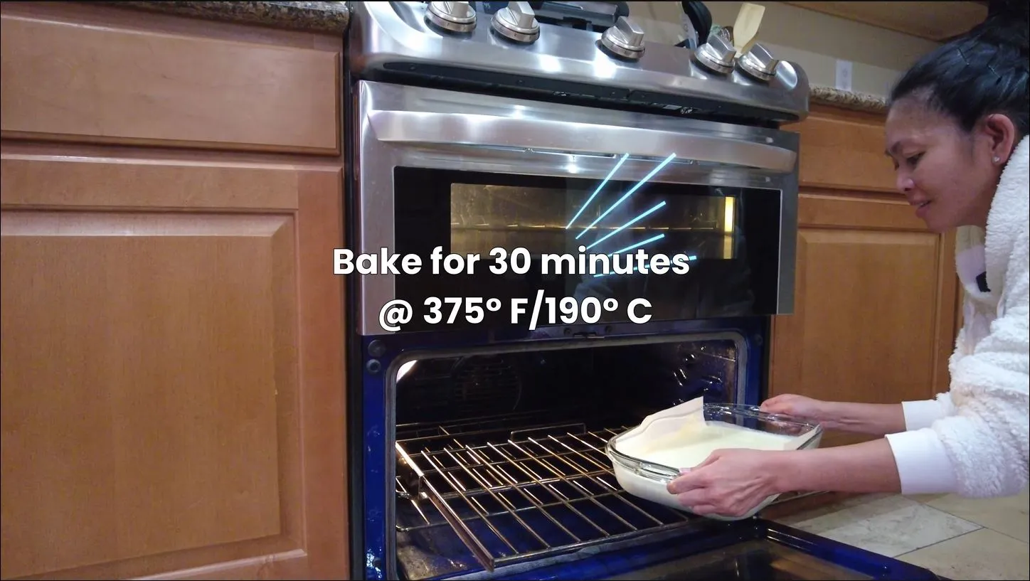 Adding the uncooked cassava cake to the oven