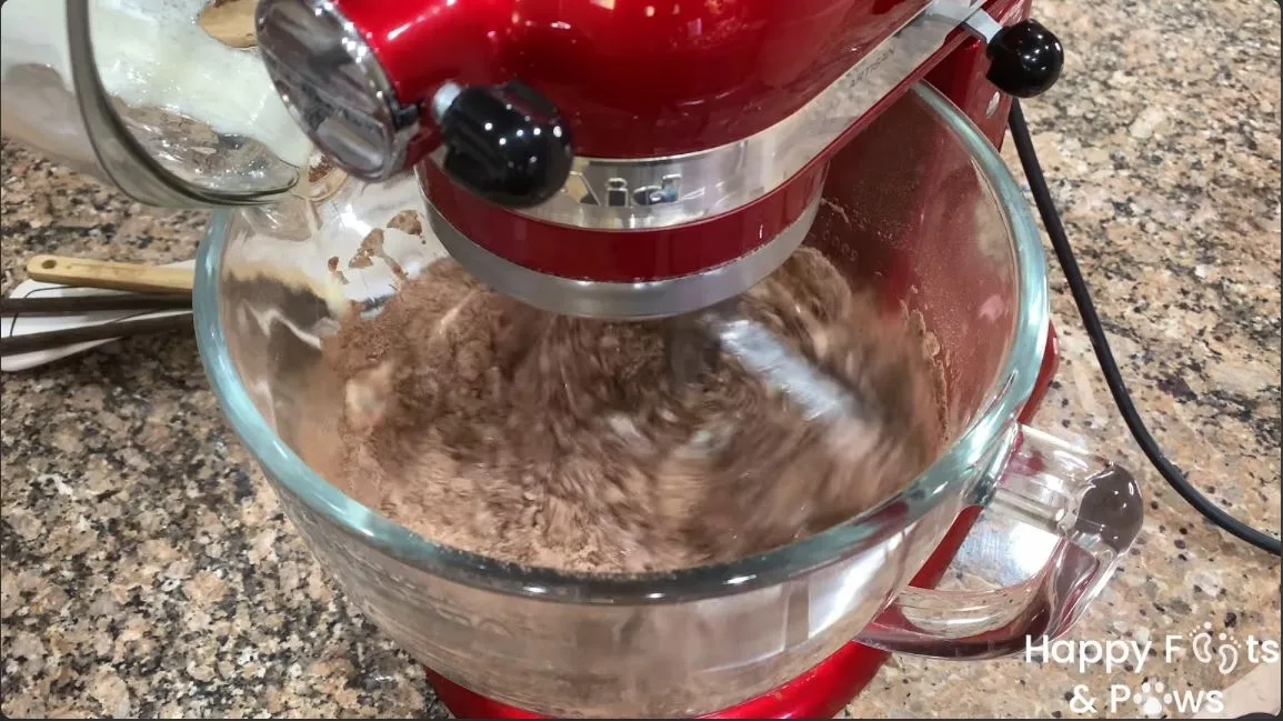 adding the wet ingredients to the dry ingredients in a stand mixer