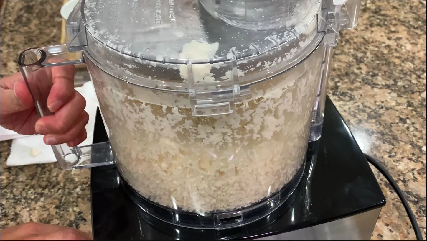 Grating cassava in a food processor using a shredding disc insert
