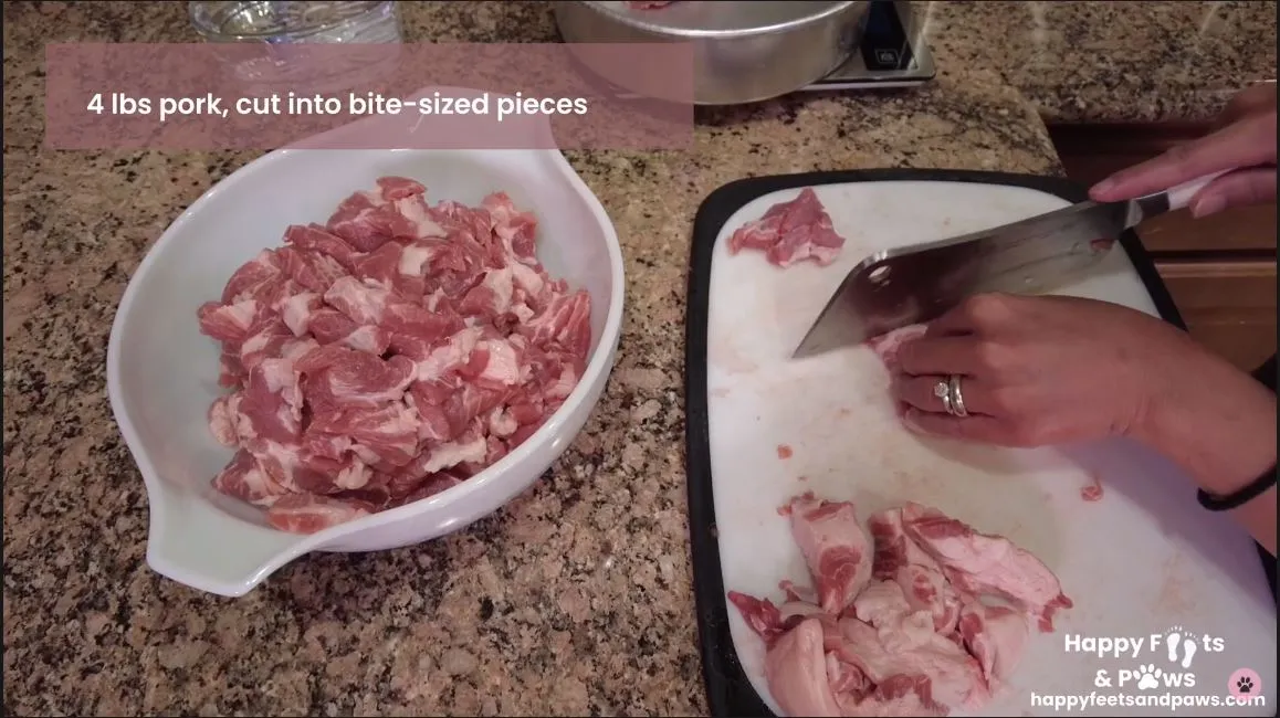 raw pork being chopped for Pork Guisantes recipe
