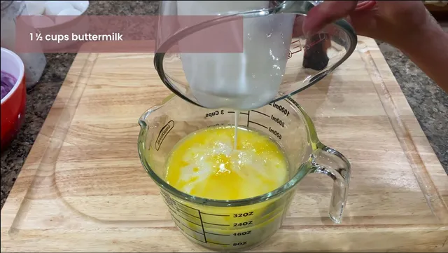 Adding wet ingredients into a measuring cup for Ube Cupcakes