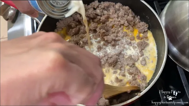 milk being added for sausage gravy in biscuits and gravy recipe