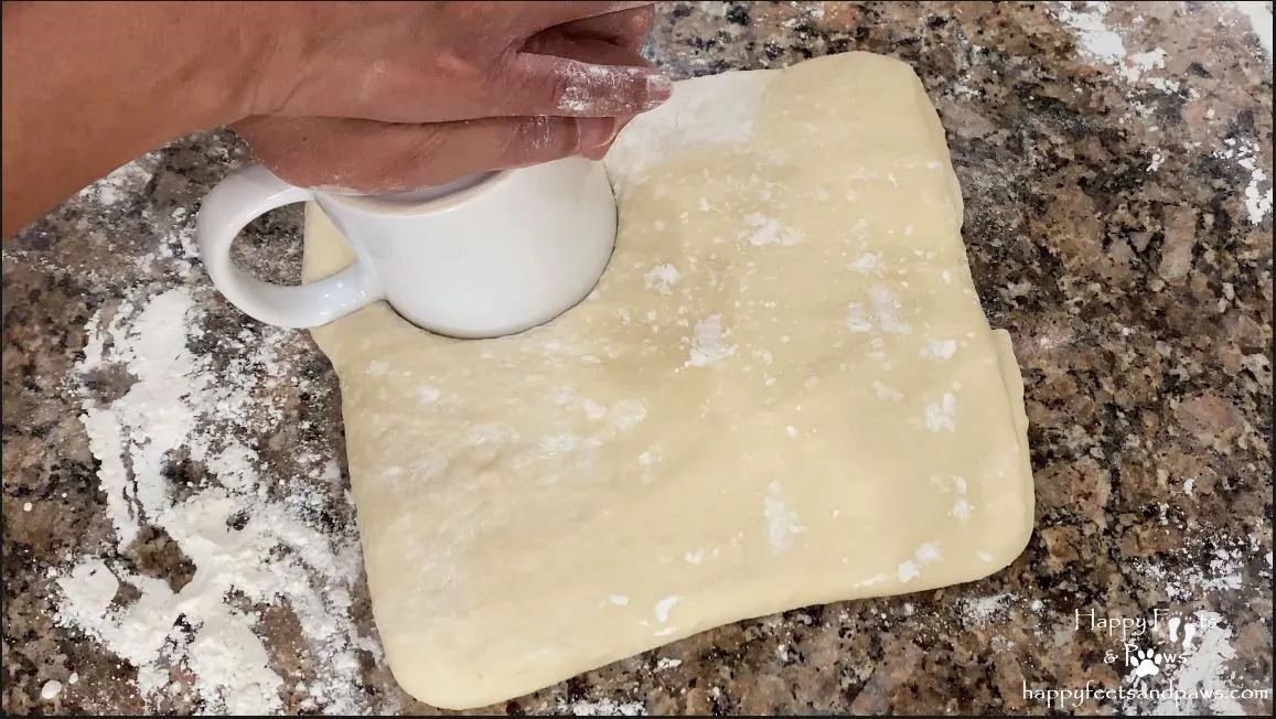 person cutting out biscuits for biscuits and gravy recipe