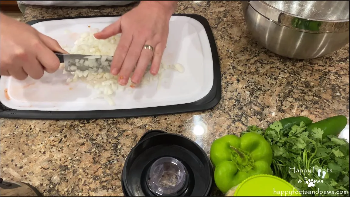 man chopping vegetables for black bean salsa recipe