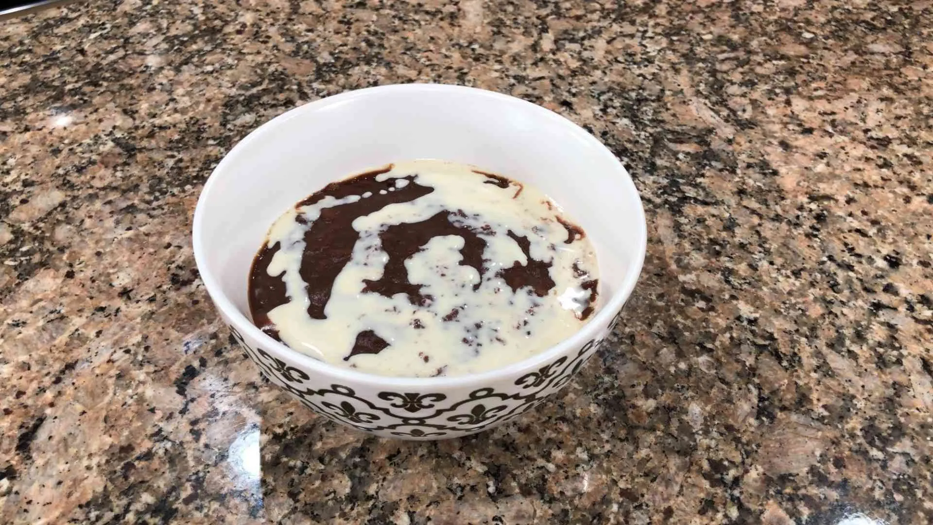 champorado in bowl with milk on top