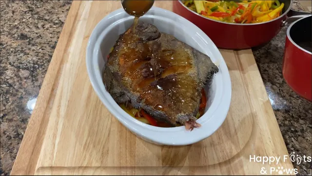 Adding sweet and sour sauce on fish in bowl