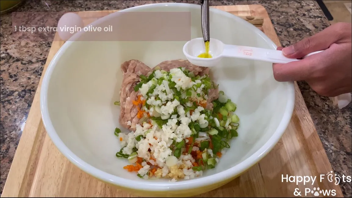 Mixing meat, onions, carrots and other ingredients in a bowl for lumpia shanghai