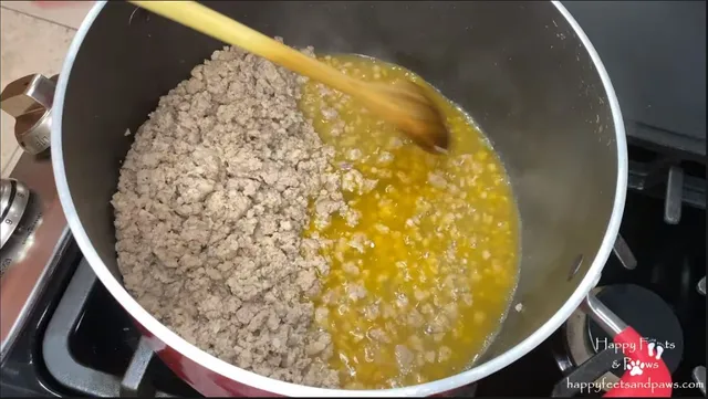 sausage being cooked in pot for spaghetti