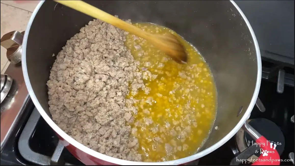 sausage being cooked in pot for spaghetti
