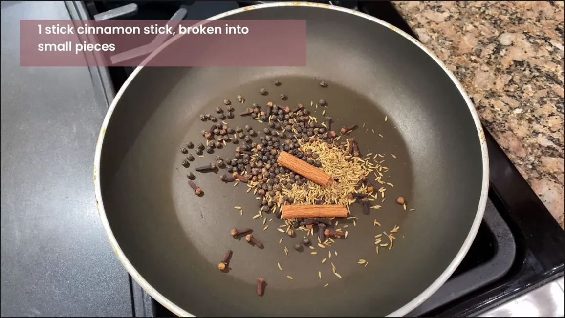 Garam Masala ingredients in a pot on a stove being dry roasted