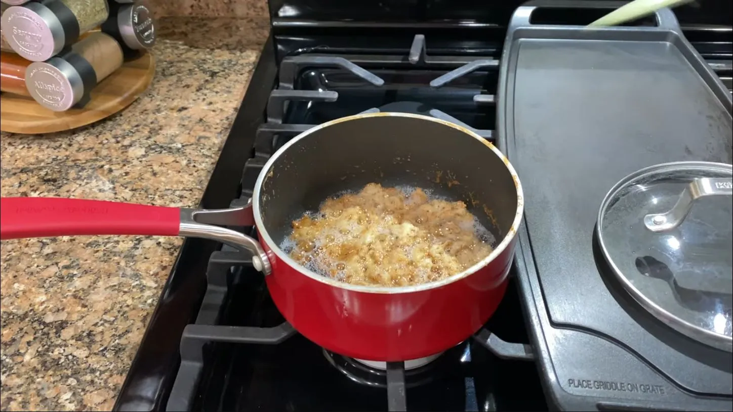 Gold brown coconut milk curds in a saucepan