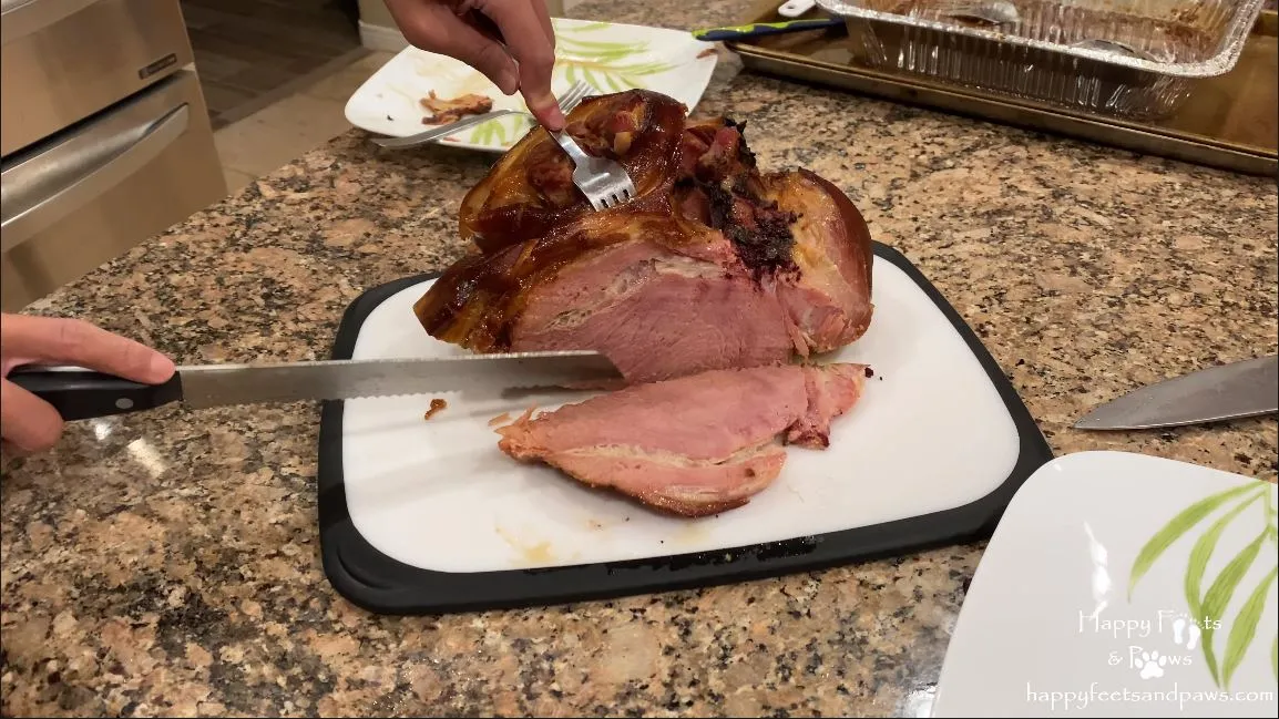 cutting a home made honey glazed ham