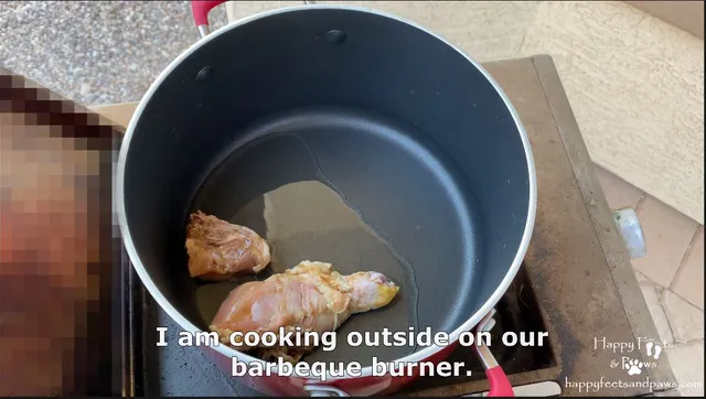 cooking meat in a pot with oil on a bbq for Filipino Adobo recipe.