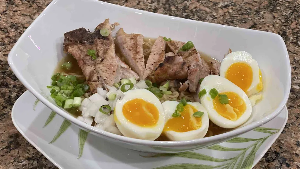 Instant Ramen Noodles with Hard Boiled egg and pork chops.