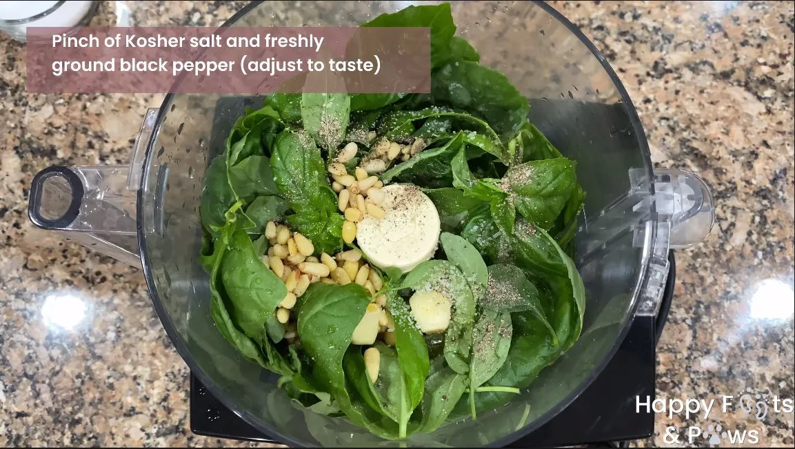 seasoning being added to food processor for basil pesto