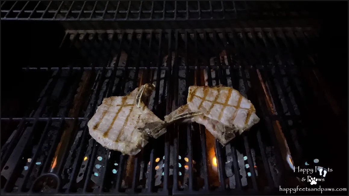 pork chops cooking on grill
