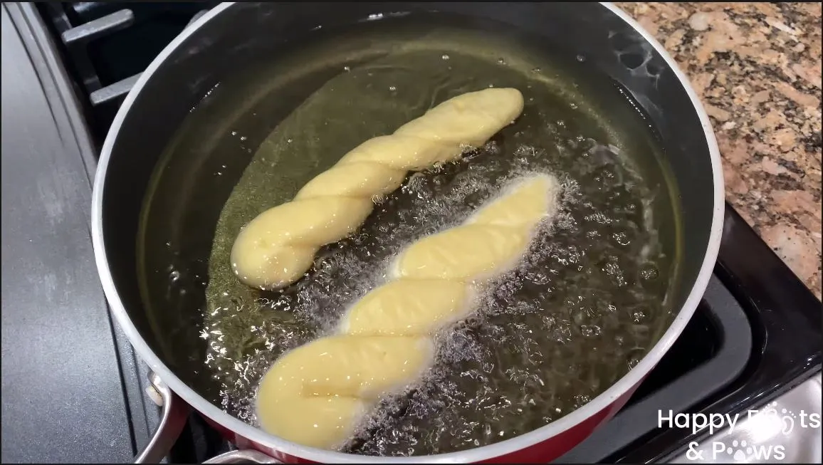 frying shakopy in a pot with oil