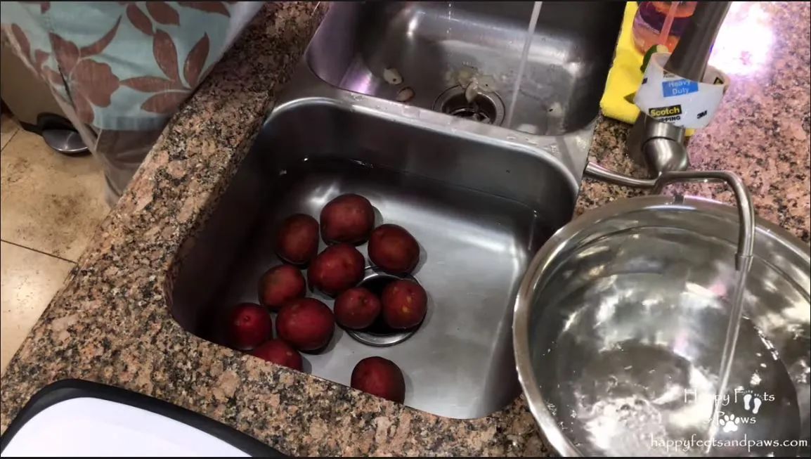 peeling potatos in the sink