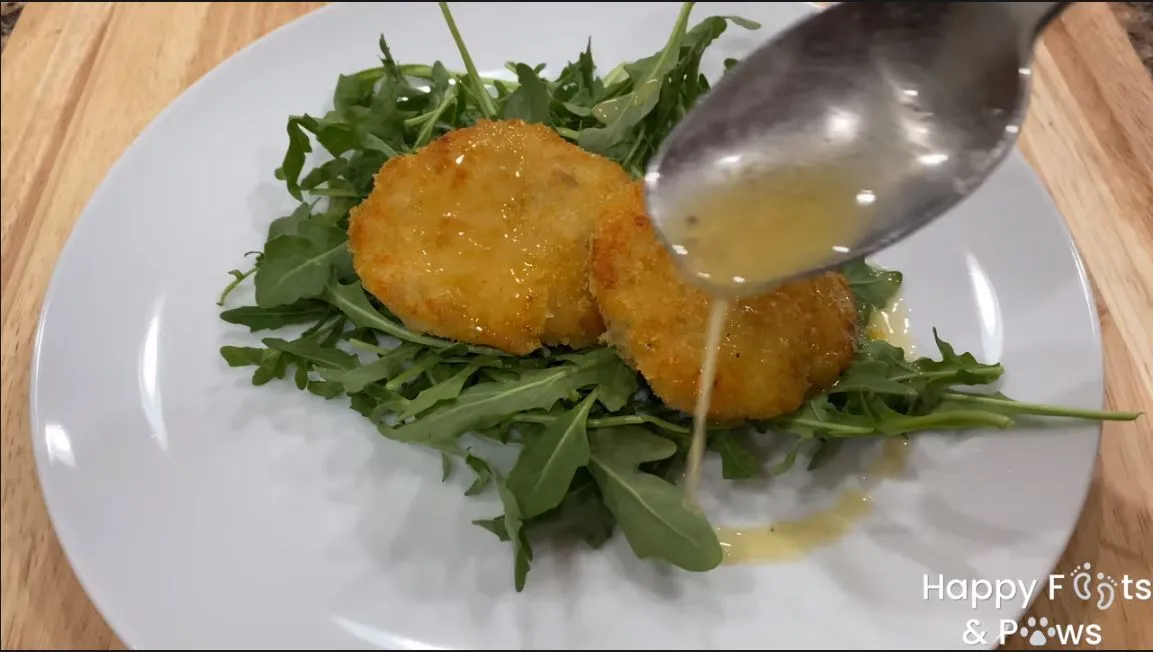 adding beurre blanc sauce to shrimp cakes