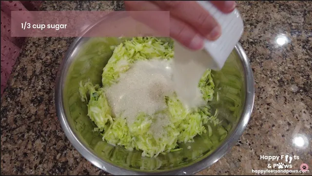 Sugar being added to zucchini bread batter